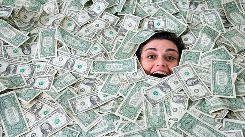 A woman drowning in dollars